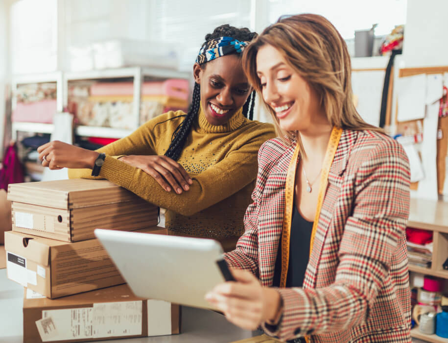 Young businesswomen looking at tablet