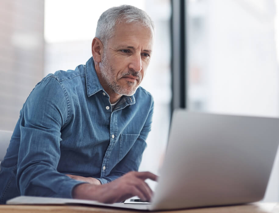 Mature man working on laptop