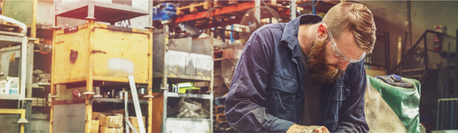 Blue collar worker wearing safety glasses